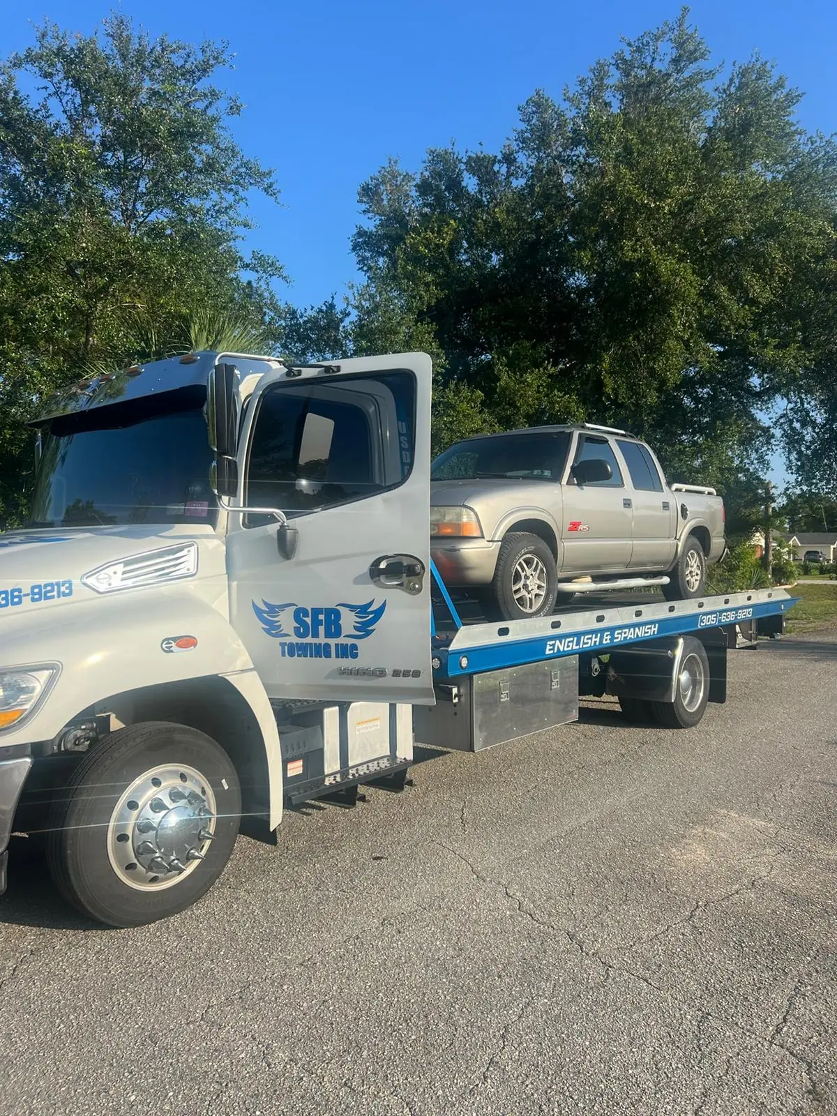 SFB Towing flatbed with a gold SUV on the bed