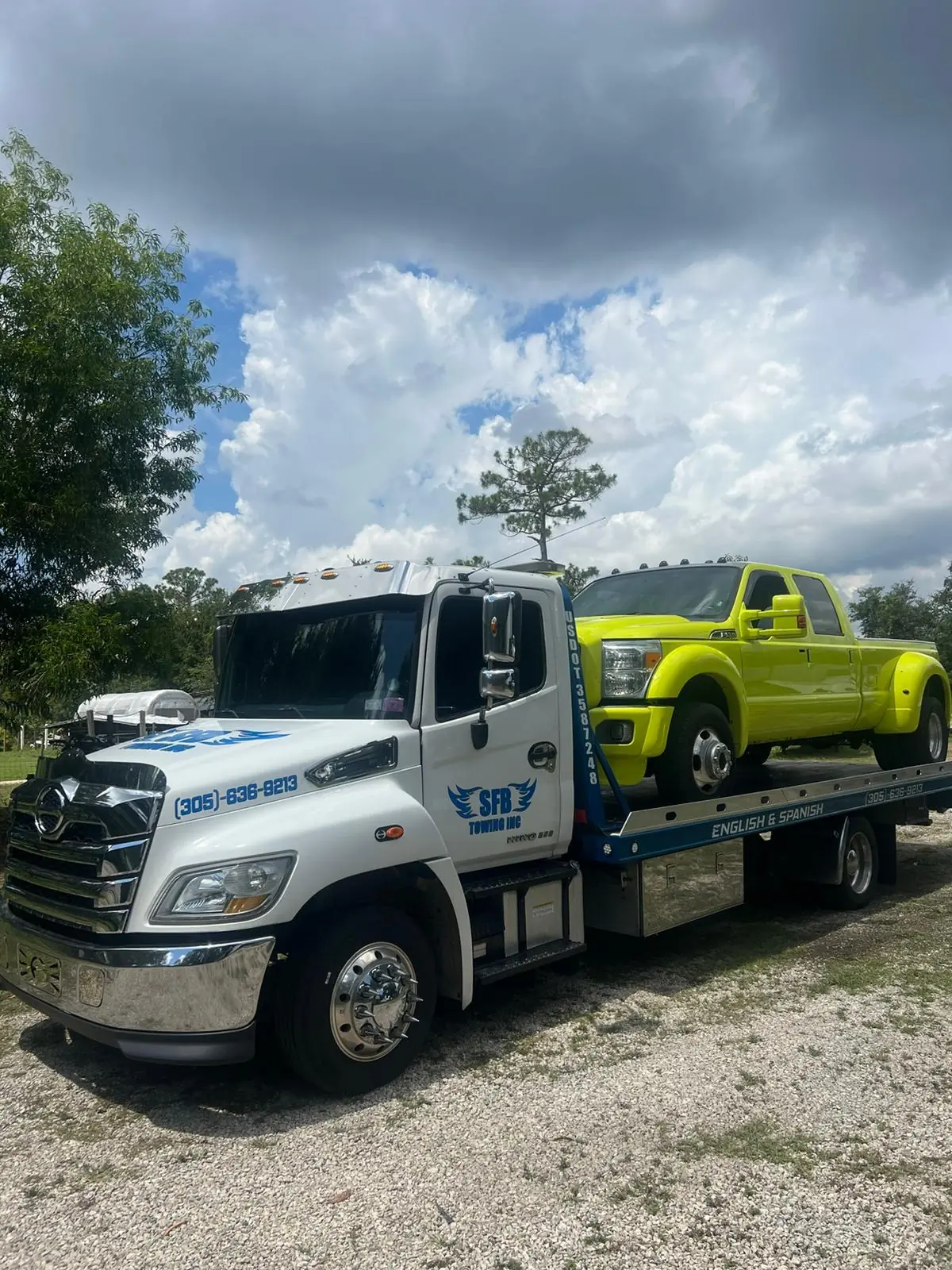 SFB Towing flatbed hauling a yellow Ford F-450 dually